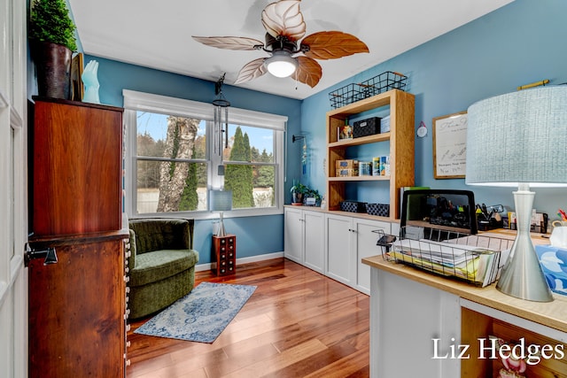 living area with light hardwood / wood-style floors and ceiling fan