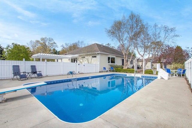 view of swimming pool featuring a diving board, a pergola, and a patio