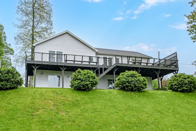 rear view of house with a lawn and a wooden deck