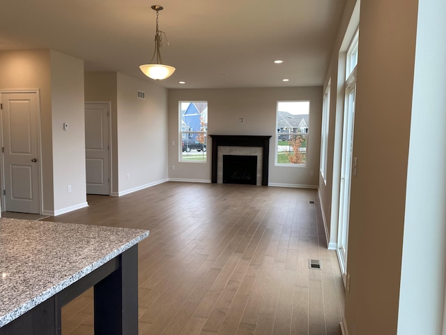 unfurnished living room with dark wood-type flooring