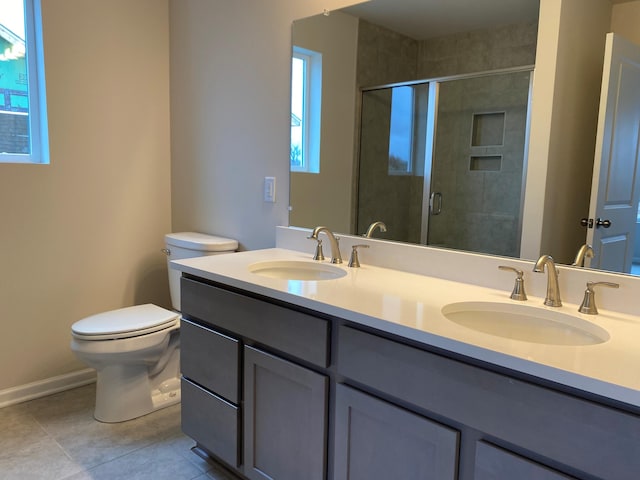 bathroom with toilet, an enclosed shower, vanity, and tile patterned floors