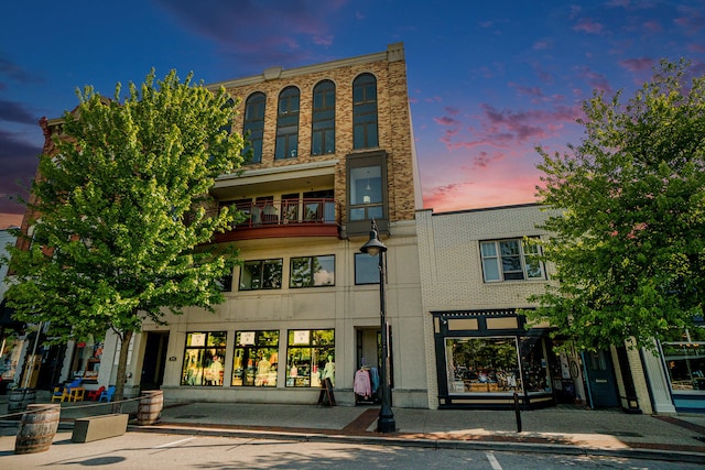 view of outdoor building at dusk