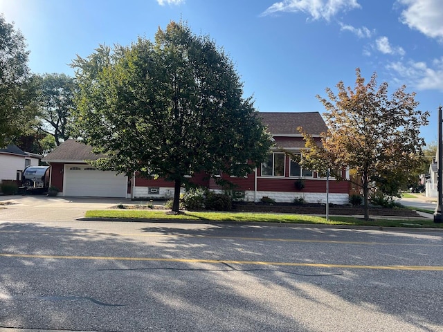 obstructed view of property with a garage