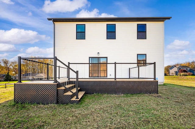 rear view of property featuring a wooden deck and a yard