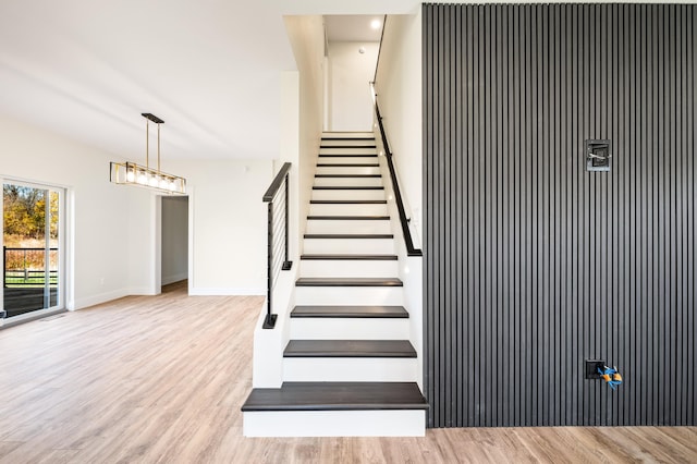 stairway with hardwood / wood-style flooring