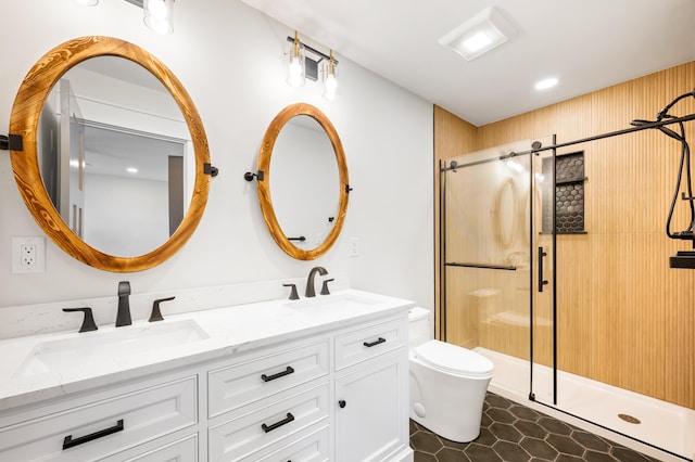 bathroom featuring tile patterned floors, vanity, an enclosed shower, and toilet