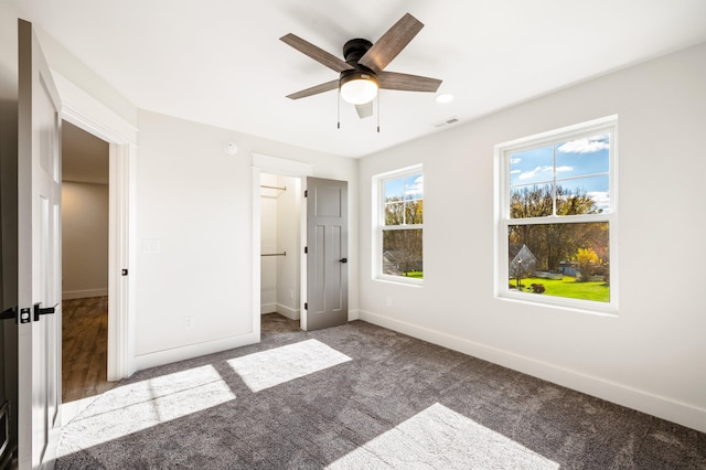 unfurnished bedroom featuring carpet and ceiling fan