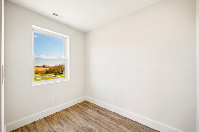 unfurnished room with wood-type flooring