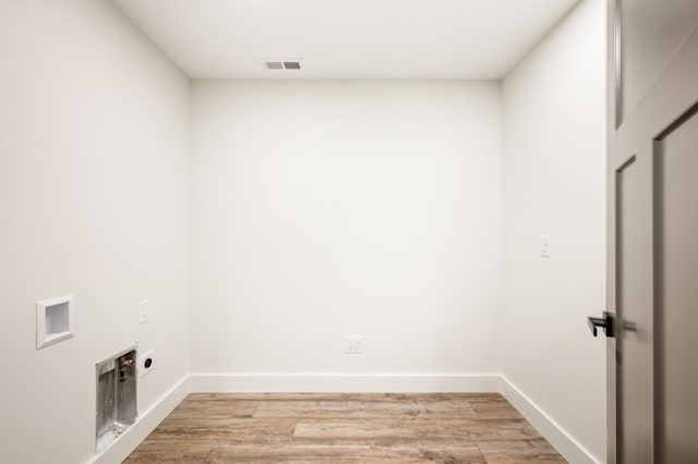 laundry area with electric dryer hookup, light hardwood / wood-style floors, and washer hookup