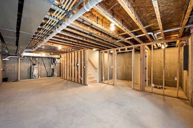 basement featuring gas water heater and electric panel