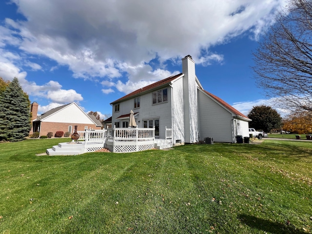 212 Saint Anne Ln, Monroe, MI 48162 - rear view of house with a wooden deck, a yard, a chimney, and central AC