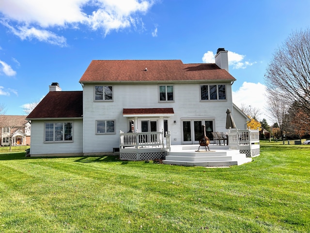 212 Saint Anne Ln, Monroe, MI 48162 - rear view of property featuring a chimney, a deck, and a lawn