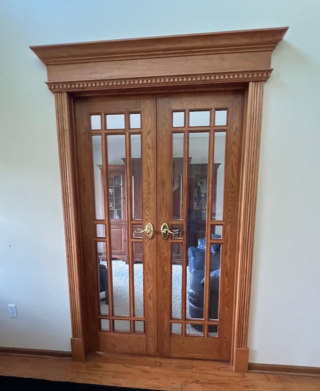 212 Saint Anne Ln, Monroe, MI 48162 - detailed view of french doors, wood finished floors, and baseboards