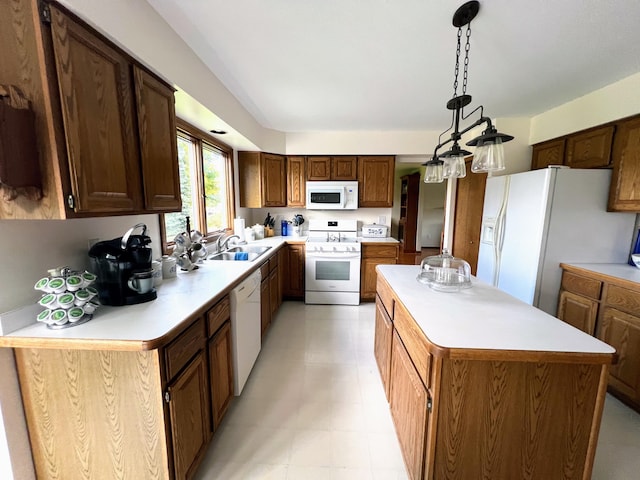 212 Saint Anne Ln, Monroe, MI 48162 - kitchen with white appliances, a kitchen island, light countertops, a sink, and hanging light fixtures