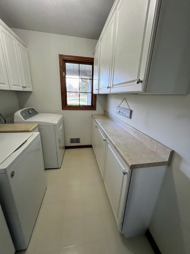 212 Saint Anne Ln, Monroe, MI 48162 - washroom featuring cabinet space, independent washer and dryer, and light flooring