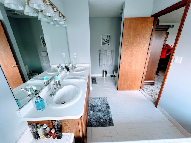 212 Saint Anne Ln, Monroe, MI 48162 - full bath featuring toilet, double vanity, baseboards, and tile patterned flooring