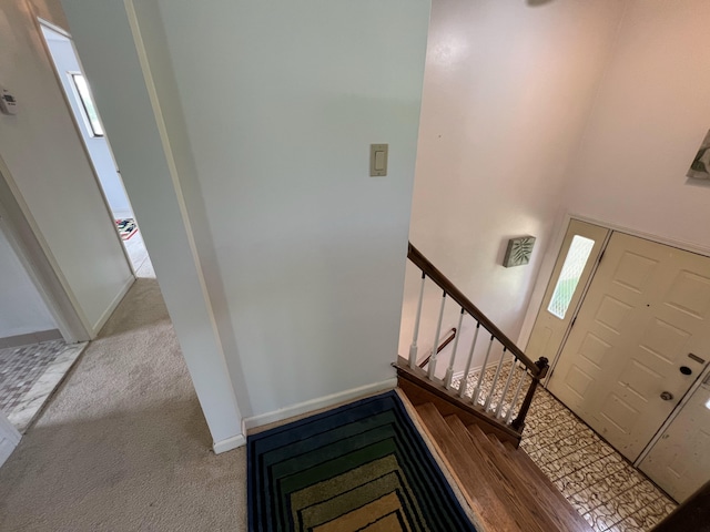 carpeted foyer featuring a high ceiling