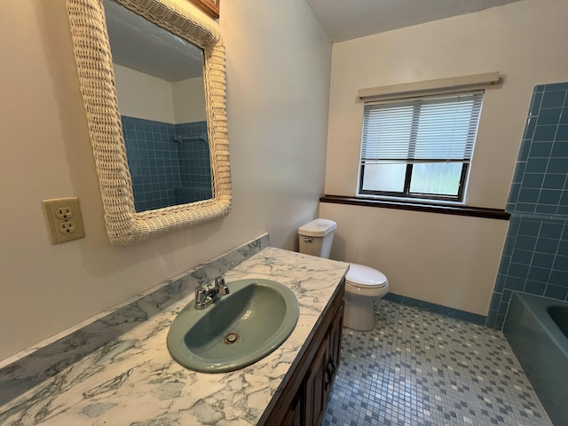 full bathroom featuring tile patterned flooring, vanity, toilet, and tiled shower / bath