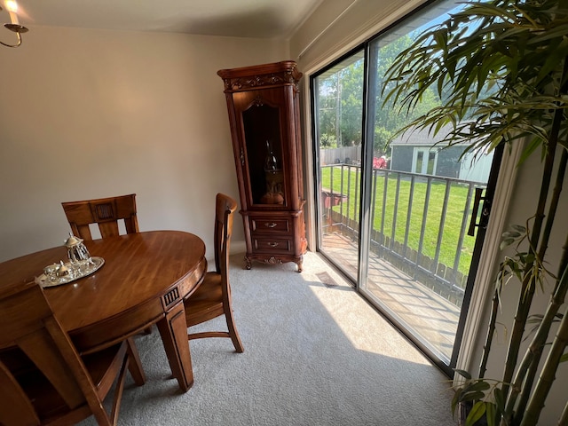 dining area featuring light carpet