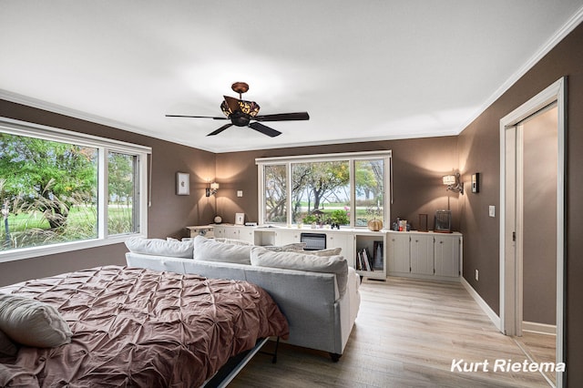 bedroom with crown molding, ceiling fan, and light hardwood / wood-style flooring