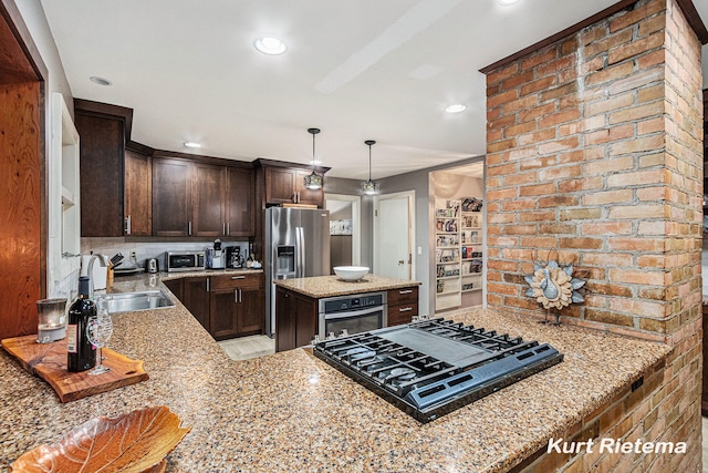 kitchen with sink, kitchen peninsula, light stone counters, black gas cooktop, and oven