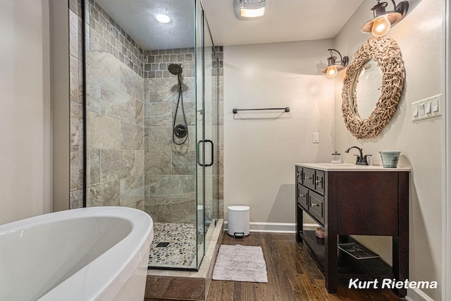 bathroom with vanity, shower with separate bathtub, and hardwood / wood-style floors