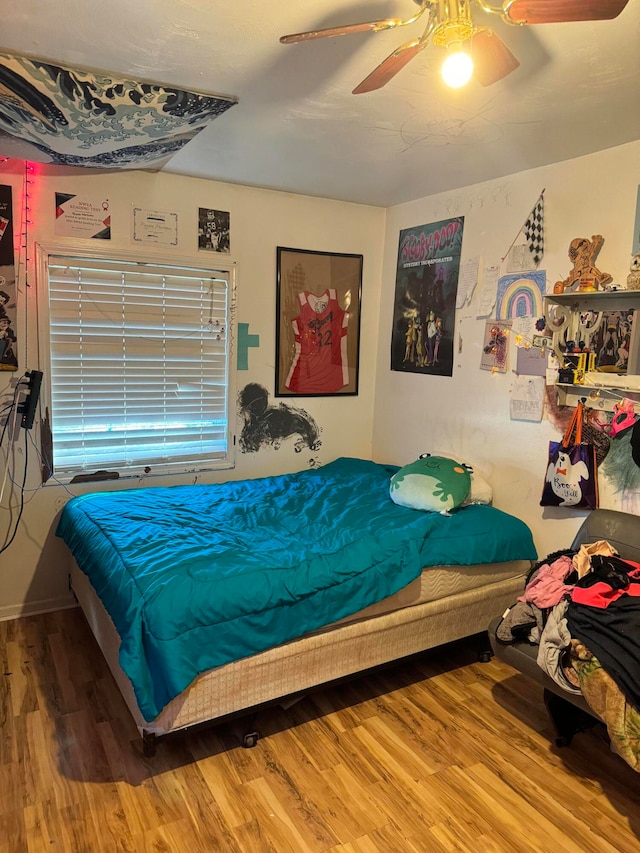 bedroom with wood-type flooring and ceiling fan