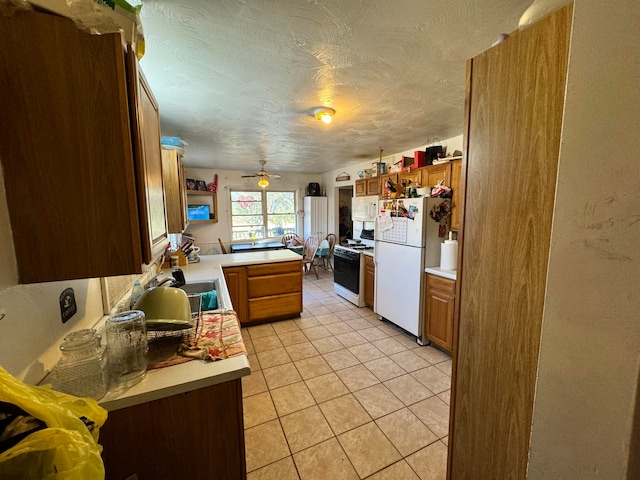 kitchen featuring sink, kitchen peninsula, ceiling fan, light tile patterned floors, and white appliances