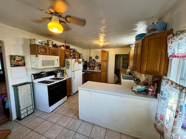 kitchen with white appliances, light tile patterned floors, sink, kitchen peninsula, and ceiling fan