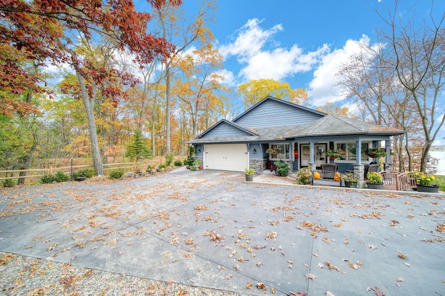 view of side of home featuring a porch and a garage