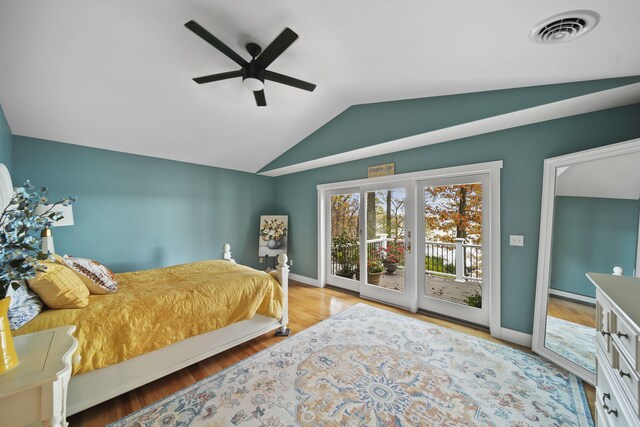 bedroom featuring access to exterior, hardwood / wood-style floors, vaulted ceiling, and ceiling fan