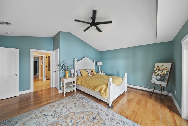 bedroom featuring baseboard heating, ceiling fan, lofted ceiling, and hardwood / wood-style flooring