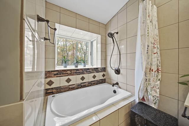 bathroom with shower / bathtub combination with curtain and tile walls