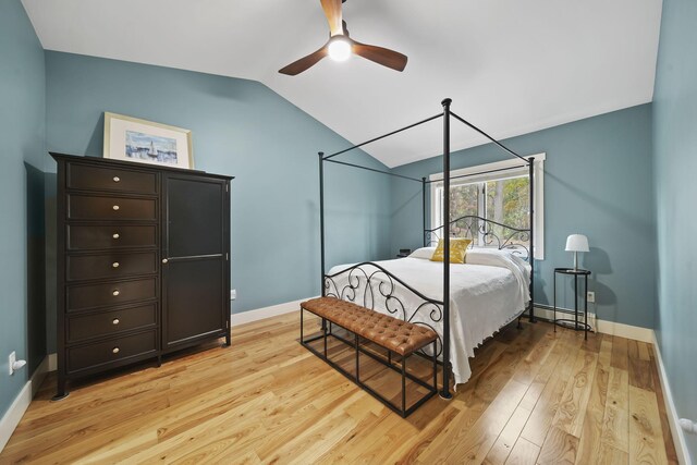 bedroom with ceiling fan, lofted ceiling, and light hardwood / wood-style flooring