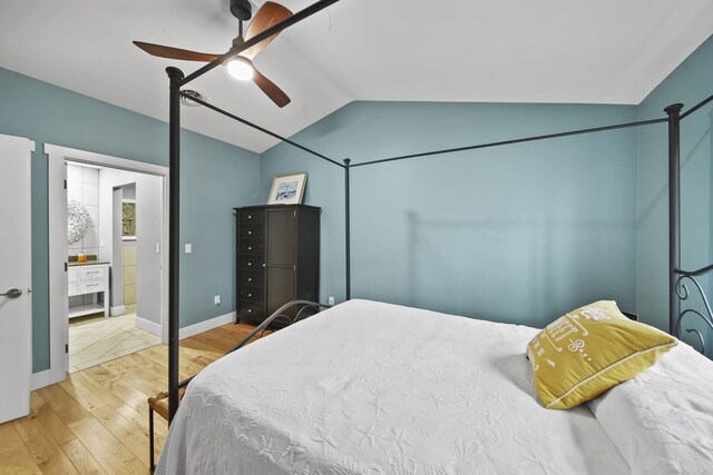 bedroom with hardwood / wood-style floors, vaulted ceiling, and ceiling fan