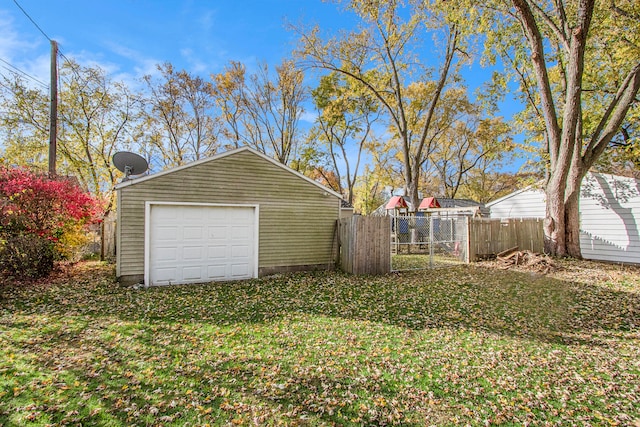 exterior space with a garage and an outbuilding