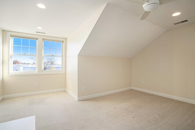 bonus room with lofted ceiling, light carpet, and ceiling fan