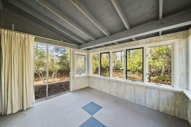 unfurnished sunroom featuring lofted ceiling