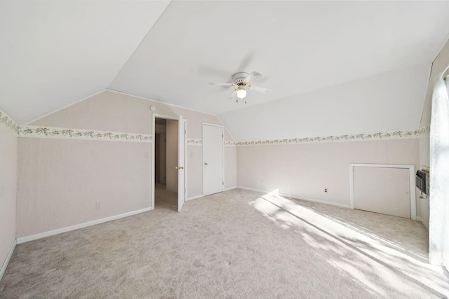 bonus room with ceiling fan, light carpet, and lofted ceiling