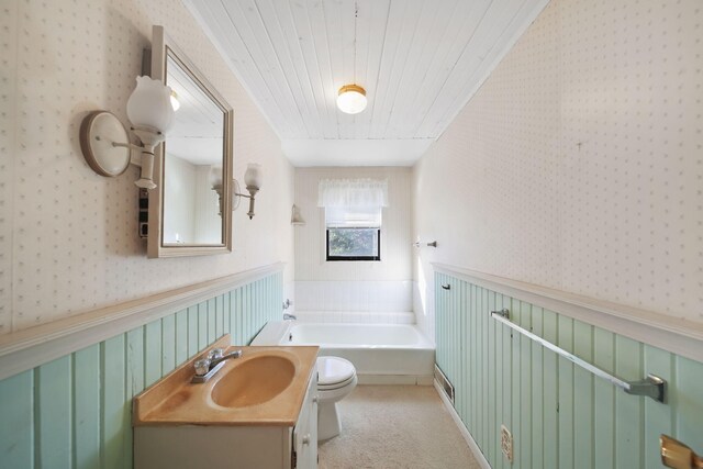 bathroom featuring vanity, a bathing tub, and toilet