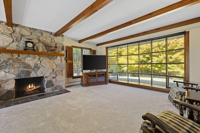 carpeted living room featuring beam ceiling, a fireplace, and a baseboard radiator