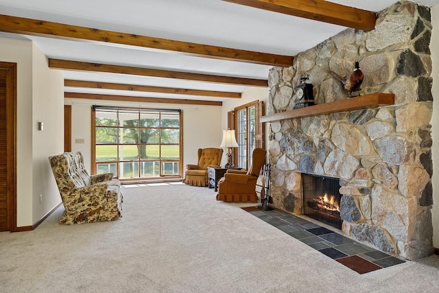 sitting room with dark colored carpet, a stone fireplace, and beamed ceiling