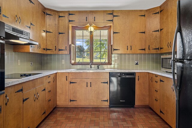 kitchen featuring decorative backsplash, sink, ventilation hood, and black appliances