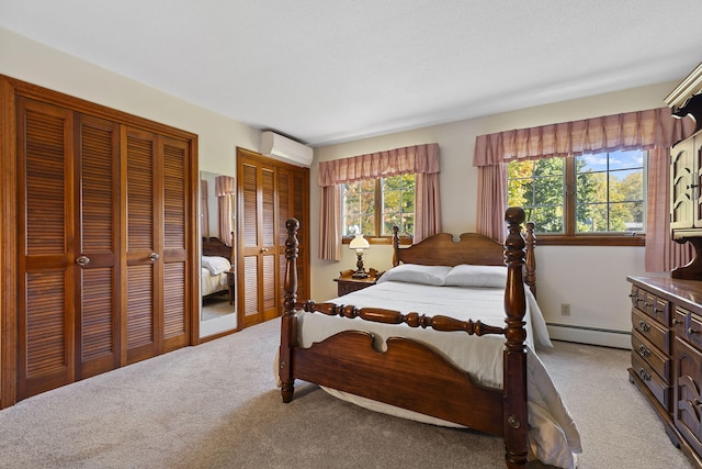 bedroom featuring a wall unit AC, multiple closets, light carpet, and a baseboard radiator