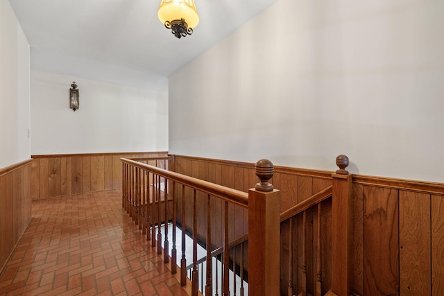 hallway with wood walls