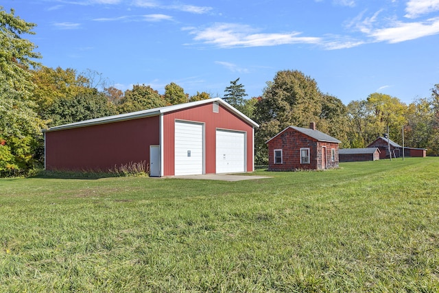 view of outdoor structure with a yard and a garage