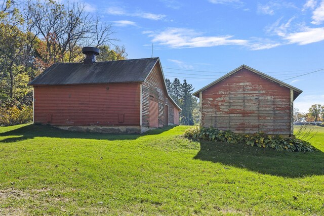 view of outbuilding with a yard