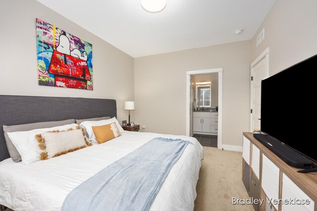 carpeted bedroom with ensuite bathroom