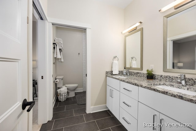 bathroom featuring toilet, vanity, and tile patterned floors