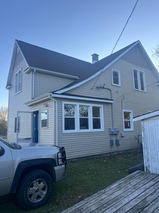 back of property featuring a wooden deck